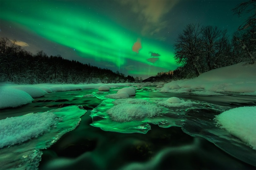Aurora shines over river, Norway